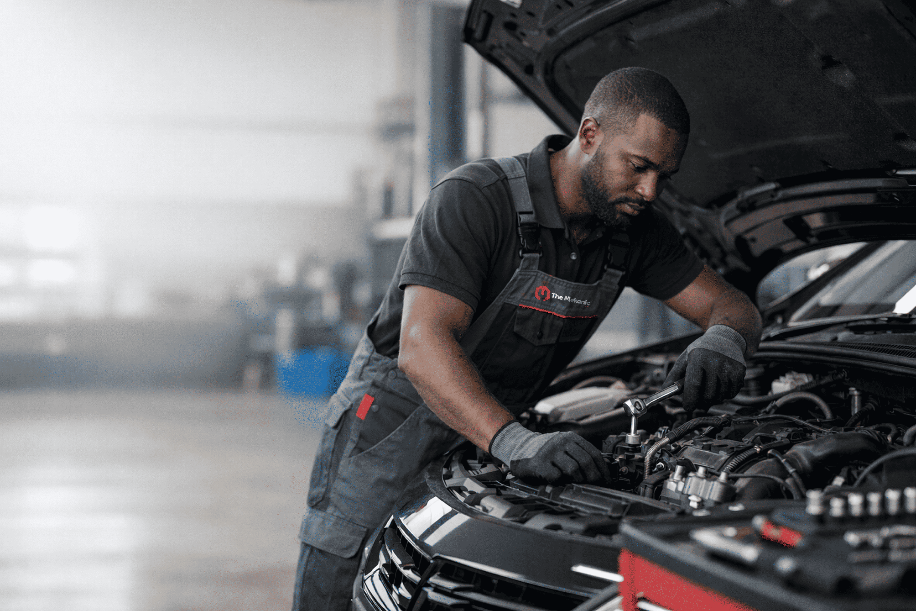 Mechanic working on car engine
